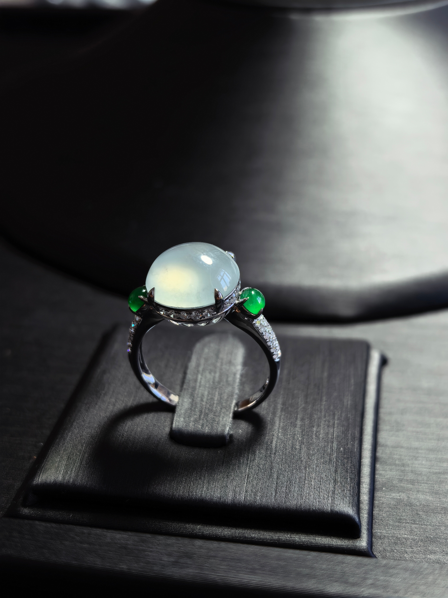 Icy jadeite cabochon ring with diamond and green jadeite accents